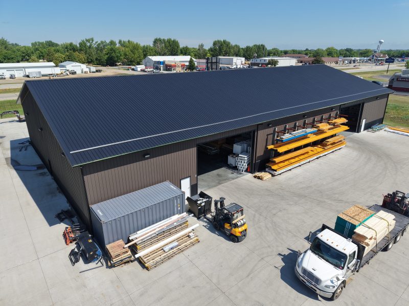 Lumber shed with delivery trucks at the yard